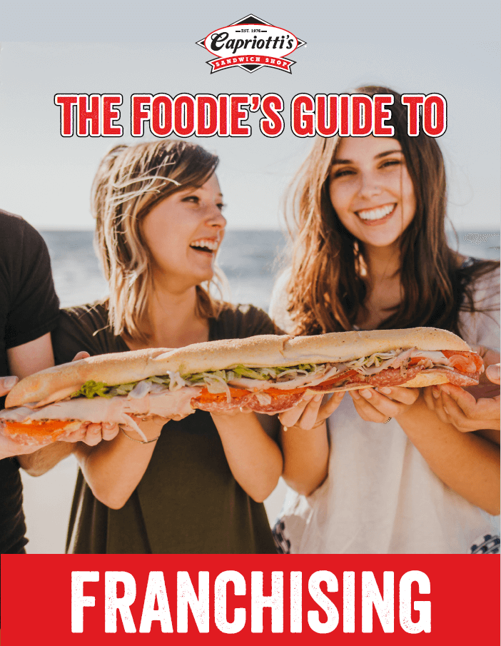 Two women holding a sandwich with "The Foodie's Guide to Franchising" title